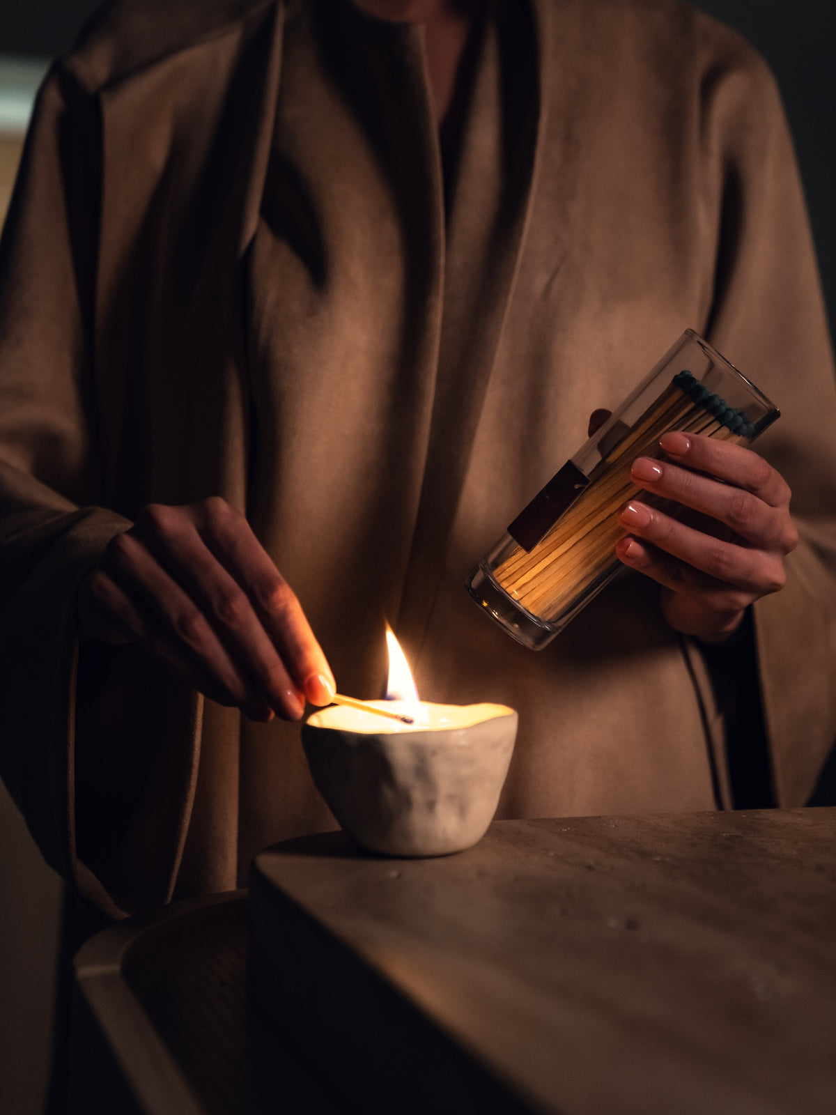 Lighting the Ruby Oud candle by Arcadia x Evada
