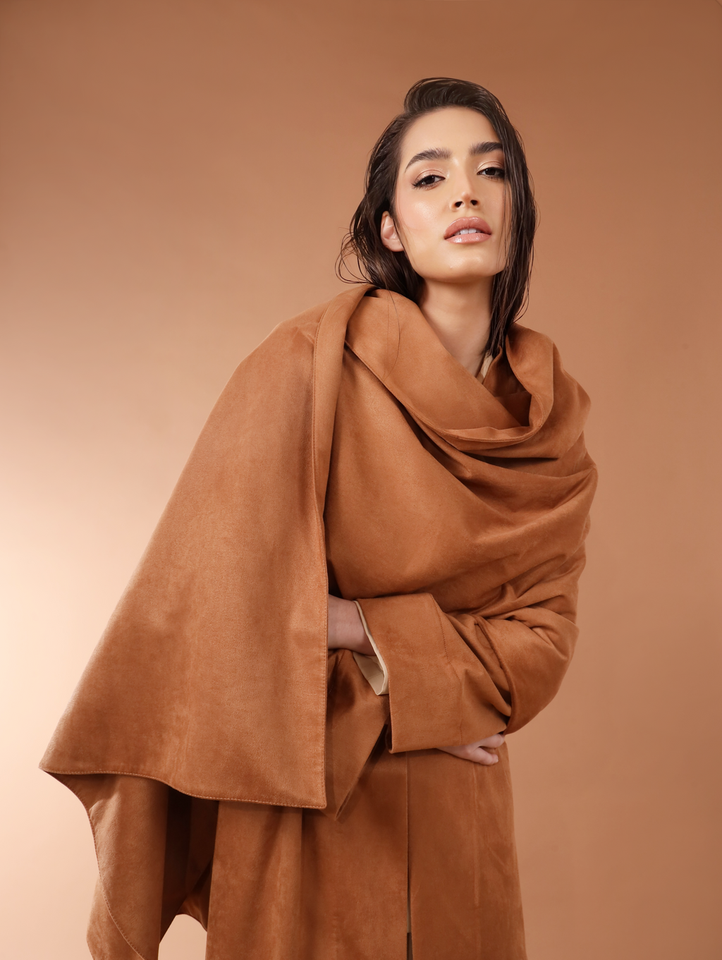 Woman wearing a brown outfit against a matching background